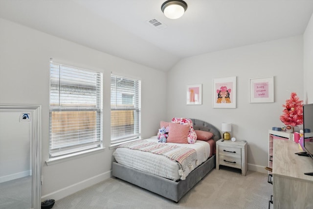 carpeted bedroom with vaulted ceiling, baseboards, and visible vents