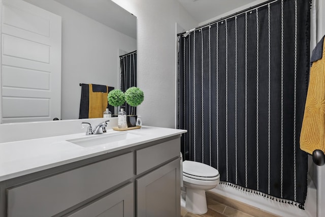 full bathroom featuring toilet and vanity