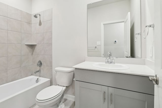 bathroom with toilet, vanity, and bathing tub / shower combination