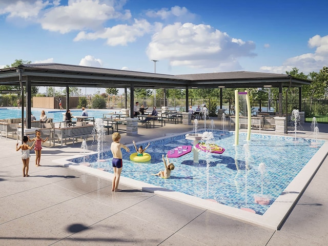 pool with a patio area, a water play area, and fence