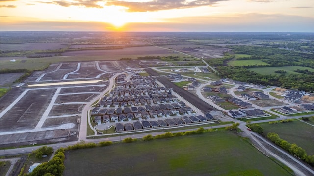 aerial view at dusk featuring a residential view