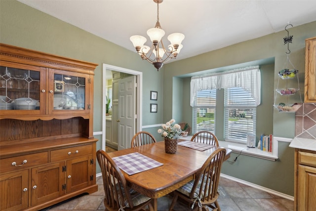 dining room featuring baseboards and a chandelier