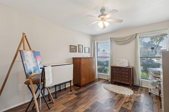 interior space featuring ceiling fan, baseboards, and dark wood-style floors