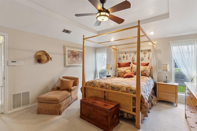 bedroom featuring light carpet, visible vents, and ceiling fan