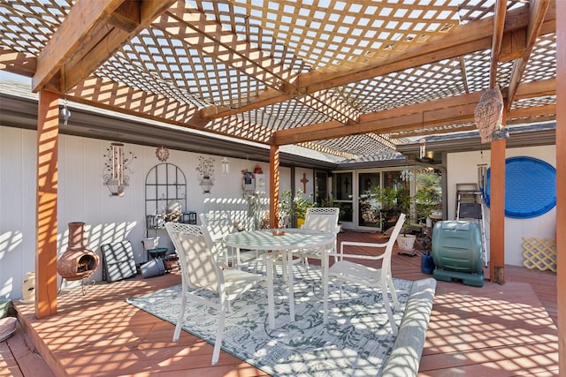 deck with a pergola and outdoor dining area