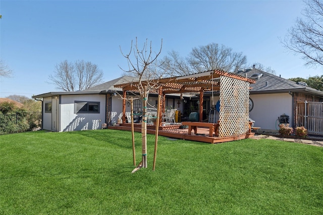 back of house with a wooden deck, fence, a lawn, and a pergola