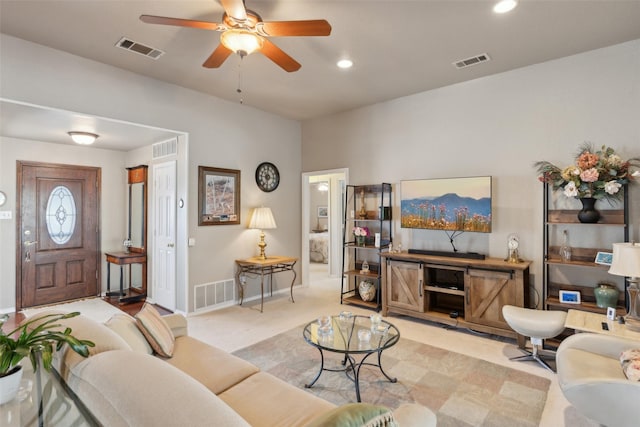 living area featuring visible vents and light carpet