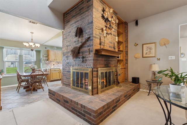 living room featuring visible vents, baseboards, a chandelier, light tile patterned floors, and a fireplace