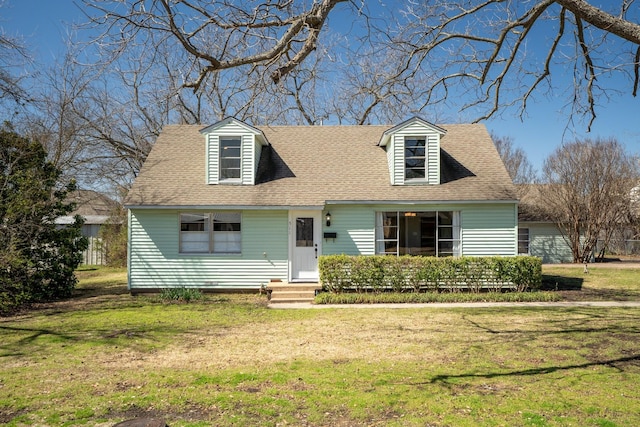 cape cod home with a front yard and roof with shingles