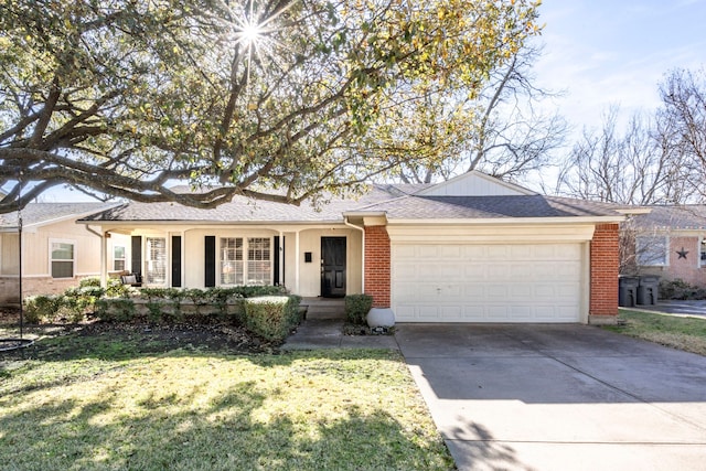 single story home featuring a front yard, driveway, roof with shingles, an attached garage, and brick siding