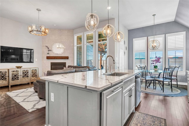 kitchen featuring a notable chandelier, dark wood-style floors, a wealth of natural light, and a sink