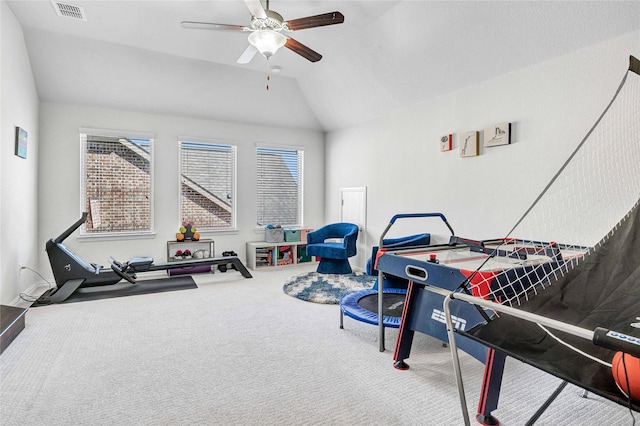 playroom with carpet flooring, visible vents, a ceiling fan, and lofted ceiling