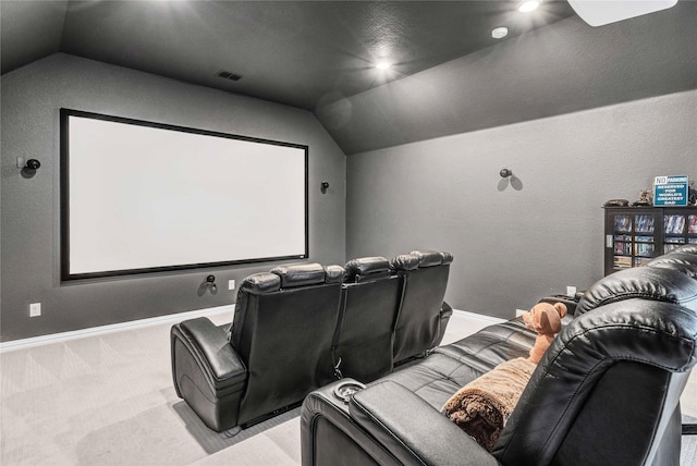 cinema room featuring visible vents, lofted ceiling, baseboards, light colored carpet, and ceiling fan