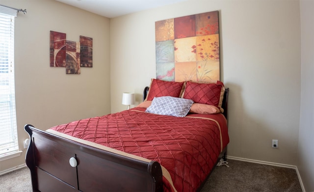 bedroom with carpet flooring and baseboards