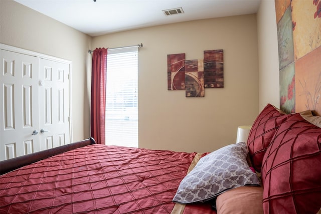 bedroom with visible vents and a closet