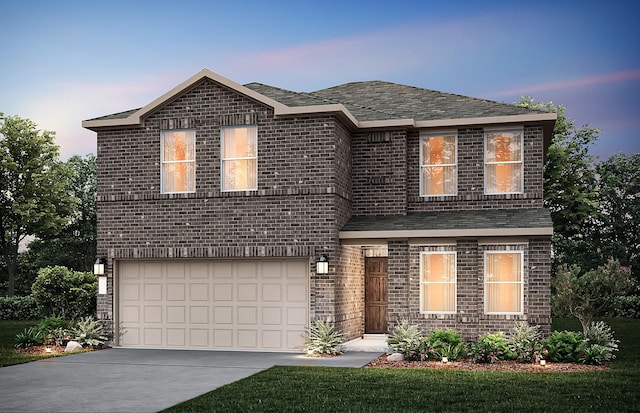 traditional-style house featuring brick siding, concrete driveway, and a garage