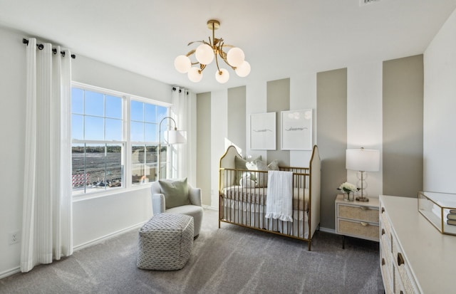 carpeted bedroom featuring baseboards and a chandelier