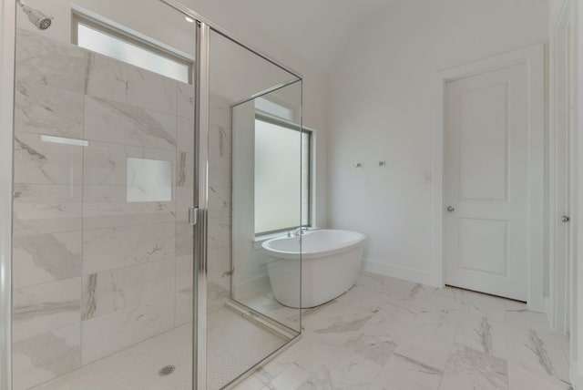 bathroom featuring baseboards, a soaking tub, a shower stall, vaulted ceiling, and marble finish floor