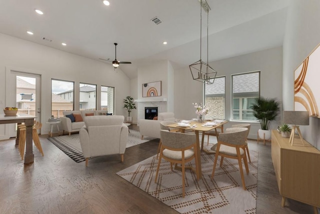 dining space featuring a glass covered fireplace, recessed lighting, visible vents, and a wealth of natural light