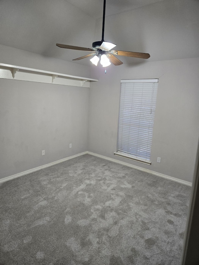 spare room featuring carpet, baseboards, and ceiling fan