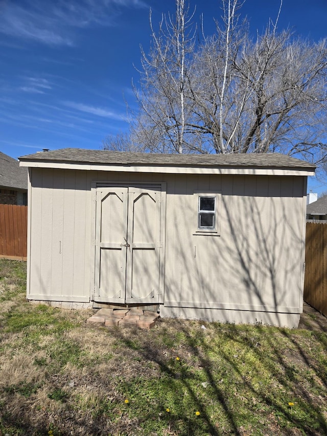 view of shed featuring fence