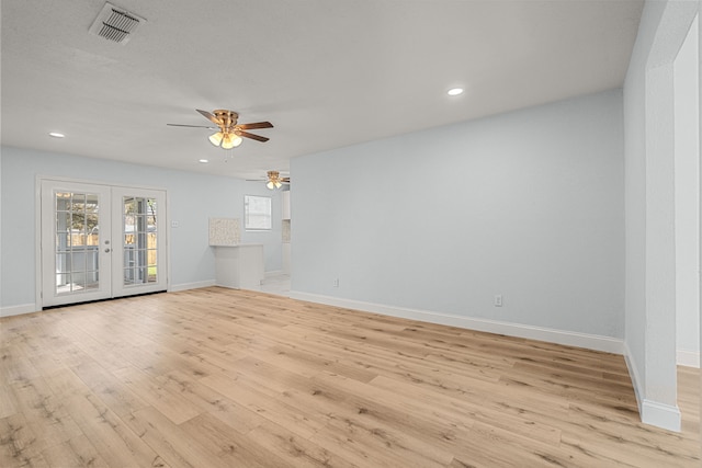 unfurnished living room featuring a ceiling fan, visible vents, baseboards, light wood-style flooring, and french doors