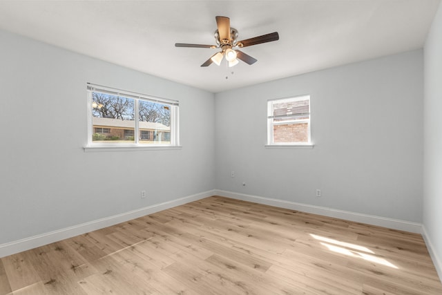 empty room featuring light wood-style floors, baseboards, and ceiling fan