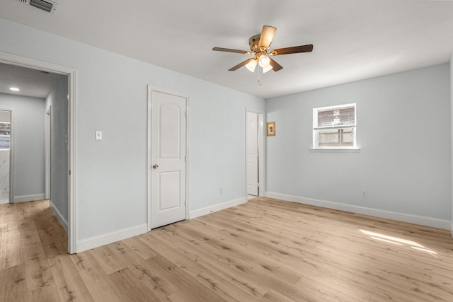 unfurnished bedroom with visible vents, baseboards, light wood-style floors, and a ceiling fan