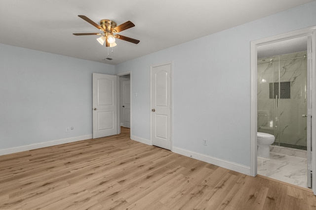 unfurnished bedroom featuring light wood-style floors, baseboards, ensuite bathroom, and ceiling fan