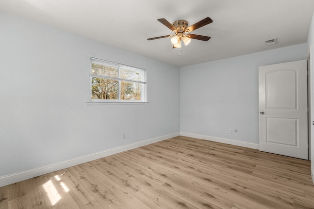 unfurnished room with visible vents, baseboards, light wood-type flooring, and a ceiling fan