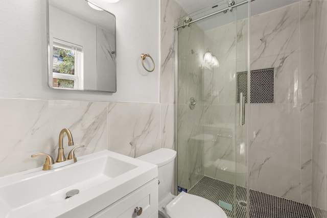 bathroom featuring a marble finish shower, toilet, vanity, and tile walls