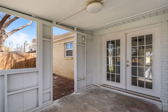 exterior space with french doors, a patio, brick siding, and fence