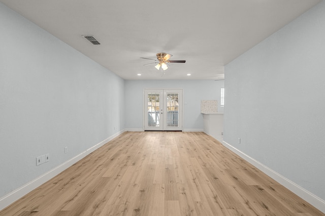 spare room featuring a ceiling fan, visible vents, baseboards, french doors, and light wood-type flooring