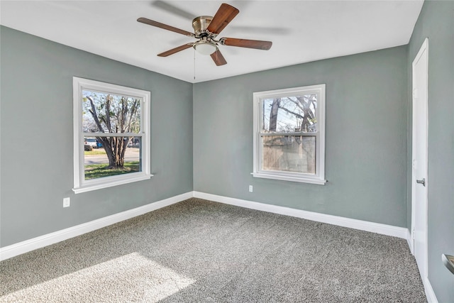 unfurnished room featuring baseboards, carpet floors, and ceiling fan