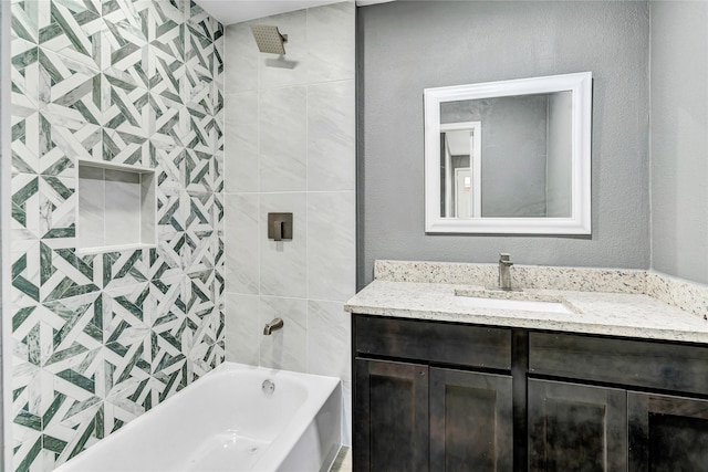 full bathroom featuring shower / washtub combination, vanity, and a textured wall