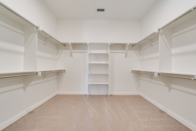 spacious closet with carpet flooring and visible vents