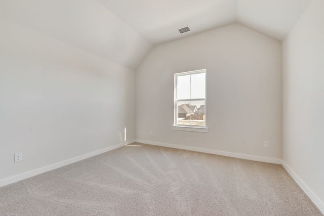 bonus room featuring visible vents, baseboards, light colored carpet, and vaulted ceiling