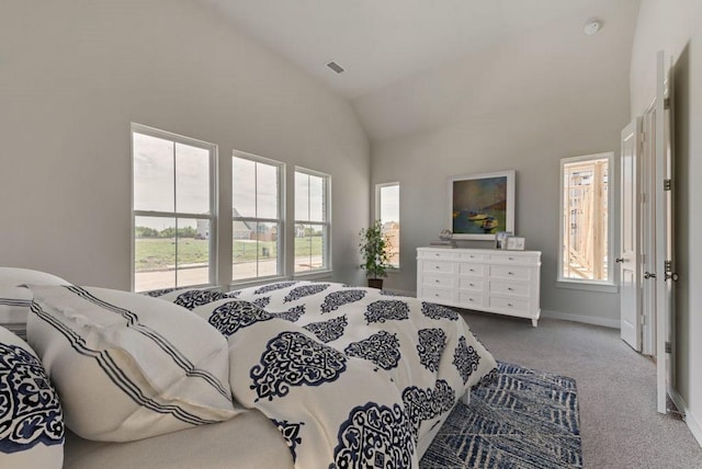 bedroom with visible vents, baseboards, carpet, and high vaulted ceiling