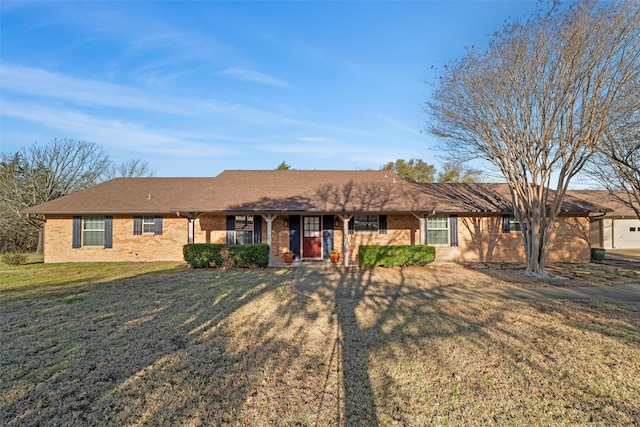 ranch-style house featuring brick siding, covered porch, and a front lawn