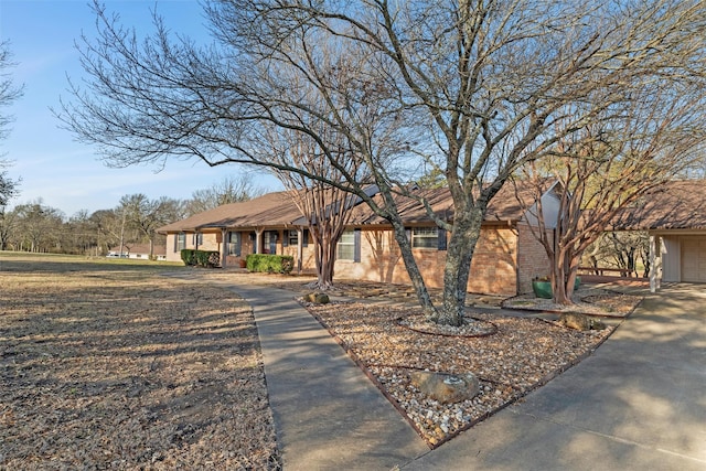 ranch-style house featuring a garage and brick siding