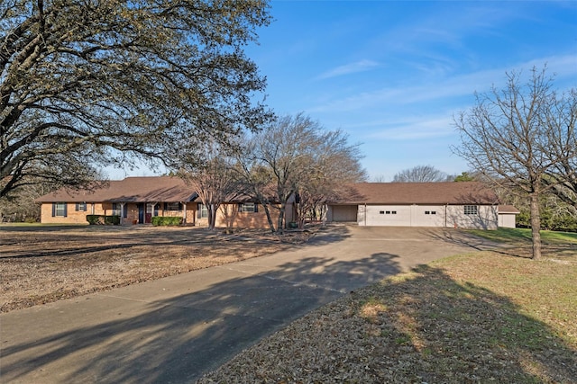 single story home with a garage and concrete driveway