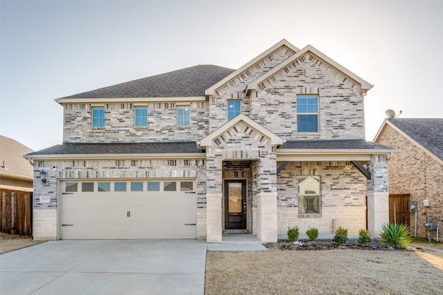 view of front of home with a garage, driveway, and a shingled roof