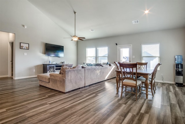 living room with visible vents, dark wood-type flooring, and ceiling fan