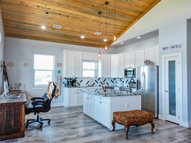 kitchen with light stone countertops, stainless steel appliances, vaulted ceiling, wood ceiling, and backsplash