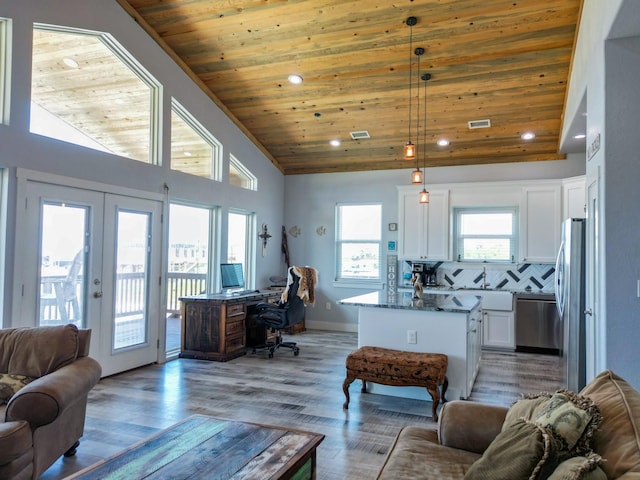 living area with visible vents, recessed lighting, french doors, and wood ceiling