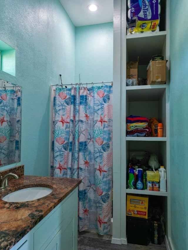 full bathroom featuring curtained shower, wood finished floors, and vanity