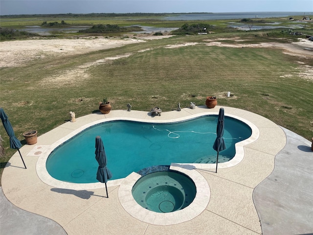 view of swimming pool with a yard and a pool with connected hot tub