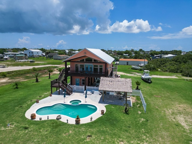 rear view of property featuring stairway, a patio, and a yard