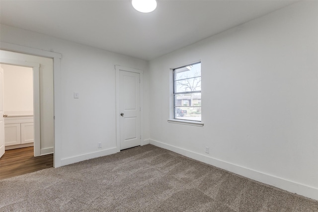 unfurnished room featuring baseboards and carpet floors