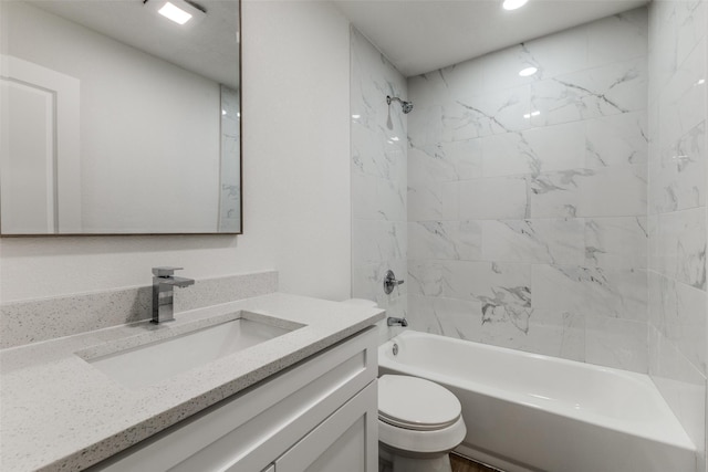 bathroom featuring vanity, toilet, and  shower combination